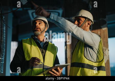 Construction workers inspecting a site with focus on planning and collaboration Stock Photo