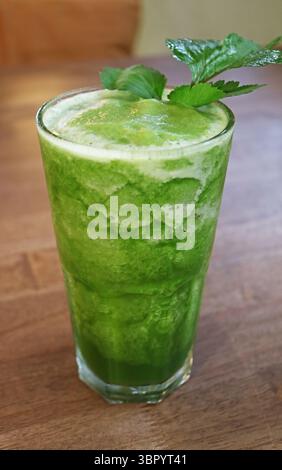 Glass of Mouthwatering Homemade Vegetable Juice on Wooden Table Stock Photo