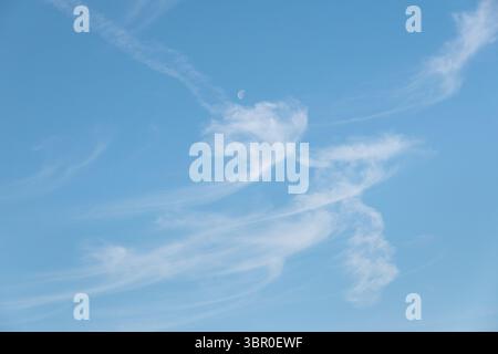 Cirrus uncinus clouds, hooked, wispy, feathery clouds made of long strands of ice crystals, often called Mare’s tails Stock Photo