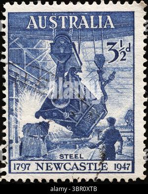 Steel mill in activity on vintage australian postage stamp Stock Photo