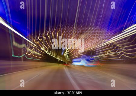 A dynamic, abstract image showcasing light trails in a Soderlanken - South link tunnel in Stockholm, creating a sense of speed and motion - vibrant co Stock Photo