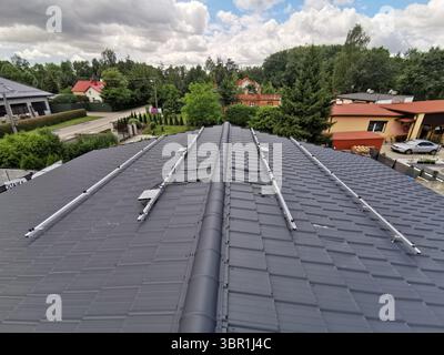 The structure on the house's tiled roof for installing solar panels, with microinverters also installed Stock Photo