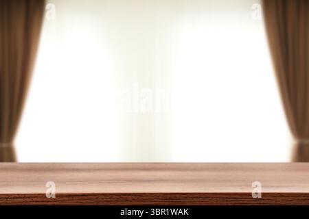 Empty wooden table against window with curtains in room Stock Photo