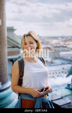 young woman against city panorama. Rooftop view Stock Photo