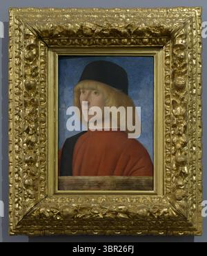 Portrait of a young man in Renaissance attire by Giovanni Bellini, 15th century, showcasing societal role through formal depiction. Stock Photo