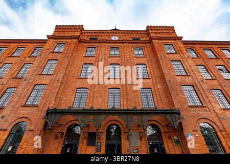 A large historic red-brick textile factory in Księży Młyn. Stock Photo