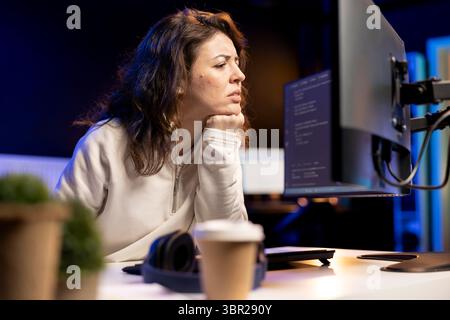 Pensive software developer thinking how to design and develop applications. Contemplative IT staff member brainstorming ways of implementing and maintaining company systems Stock Photo