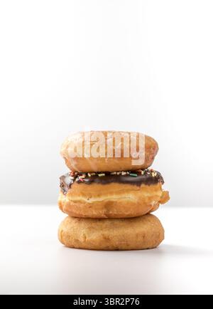 tower of assorted donuts isolated on white background Stock Photo