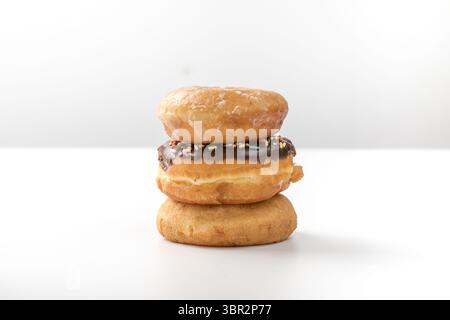 tower of assorted donuts isolated on white background Stock Photo