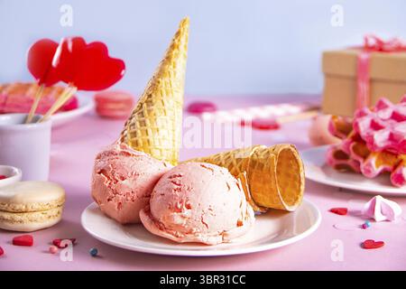 Pink ice cream cones, red sugar hearts shaped sprinkles, waffles and red lollipops. Valentines day concept Stock Photo
