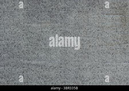 Displaying close-up speckled grey surface filling frame in flat design showcasing monochrome flecks Stock Photo