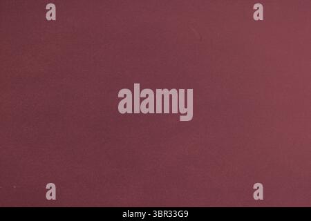 Maroon textured surface covering entire frame in flat design, suggesting fabric backdrop Stock Photo