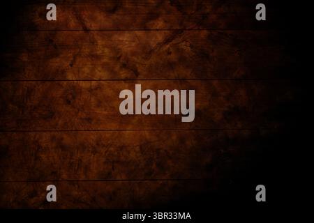 Wooden plank surface is being shown in flat design, displaying warm brown grain and moody shadows Stock Photo