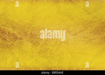 Golden grainy texture is creating uniform surface in flat design abstract background, copy space Stock Photo