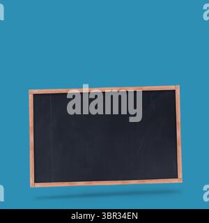 Blank chalkboard is hovering in flat design on teal backdrop, with wooden frame and drop shadow Stock Photo