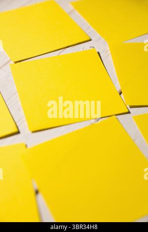 Yellow papers fallen on wooden floor Stock Photo