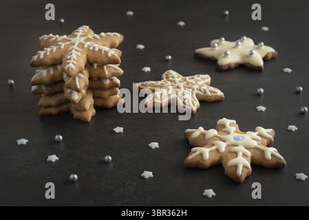 Christmas gingerbread cookies decorated with sugar icing in the form of snowflakes. Festive Christmas background Stock Photo