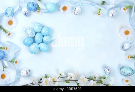 Decorated blue Easter eggs on a blue background. Minimal holiday concept. Happy easter background. Creative painting of eggs, idea of simple drawings Stock Photo