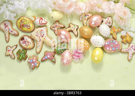 Festive easter banner, spring composition with decorated eggs, cookies and blooming flowers, creative concept of easter, ideas for home decorations, s Stock Photo
