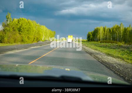 dark sky before or after rainstorm and a highway, summertime shot Stock Photo