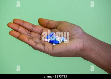 Close-up of a woman's hand holding various pills and capsules. Concepts of depression, overdose, suicide, drug addiction, narcotic abuse, and mental h Stock Photo