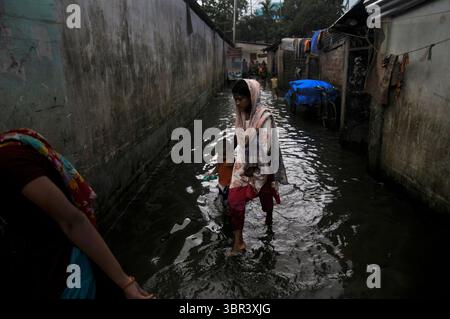 July 13, 2020: 13 July 2020: People seen moving through in flood water Chorar Par area due to the onrush of water from the upstream and heavy rainfall triggered by monsoon over the last few days in Sylhet. (Credit Image: © Md Rafayat Haque Khan/ZUMA Wire) Stock Photo