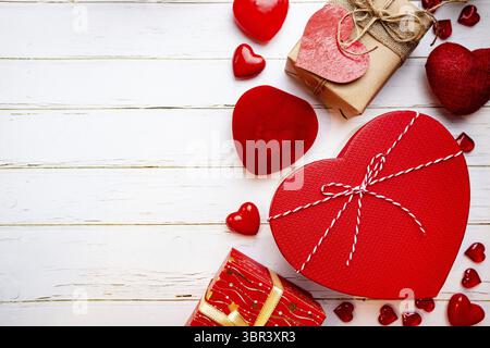 Valentine's day greeting card with different gift boxes and hearts on white wooden background Stock Photo