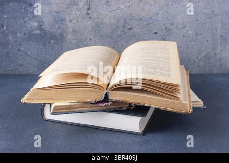 Open vintage book on blue background with copy space Stock Photo