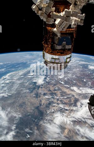June 30, 2020 - Earth's Atmosphere - The International Space Station was orbiting almost directly above Marfa, Texas, on a southeastern orbital trek that would take it over Mexico and across South America. In the foreground, is the "Dextre" fine-tuned robotic hand with Japan's H-II Transfer Vehicle-9 (HTV-9) behind it. Inside the HTV-9, is the HTV-8 pallet holding old nickel-hydrogen batteries removed from the station during previous spacewalks. (Credit Image: © NASA/ZUMA Wire/ZUMAPRESS.com) Stock Photo
