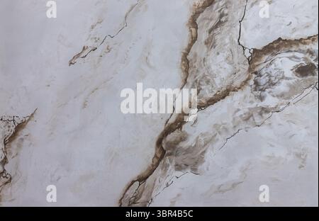 Luxurious surface displaying a marble pattern with graceful swirls and lines in white and brown creating a sophisticated ambiance suitable for various Stock Photo