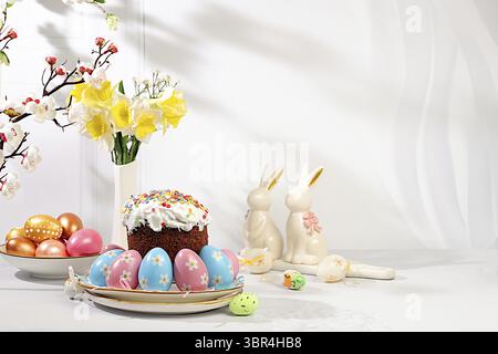 Happy Easter concept. Abstract Easter composition with traditional Russian kulich with meringue and decorated painted eggs on elegant kitchen table wi Stock Photo