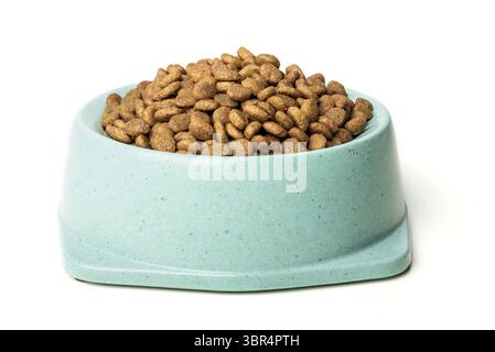 Dry cat food in green bowl isolated on white. Premium cat food Stock Photo
