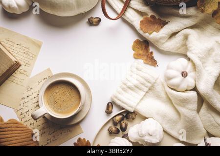 Warm coffee with pumpkins and colorful leaves over white background top view. Stylish autumn flat lay. Hello fall. Cozy warm image Stock Photo
