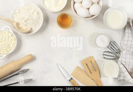 Kitchen background for baking and cooking cake, bread, confectionery and ingredients for cooking, milk, honey, flour, salt, sugar, eggs and cream on a Stock Photo