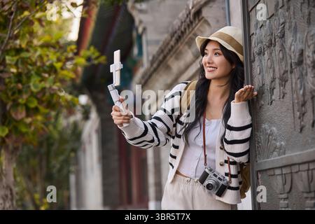Young woman discovers the magic of Beijing Stock Photo