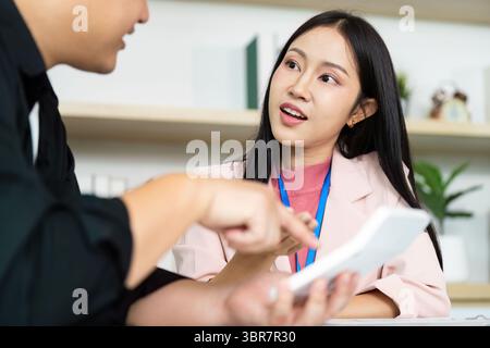 Engaging Discussion. Young professionals collaborating on a digital project. Stock Photo