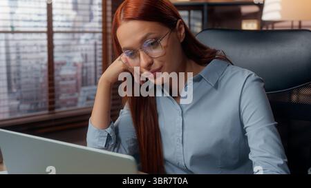 Caucasian stressed overworked exhausted burnout bored woman business girl female businesswoman worker in office working laptop online deadline Stock Photo