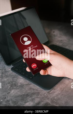 Woman receiving unwanted call on smartphone while working. Spam, scam, phishing and fraud concept. Security technology. Stock Photo