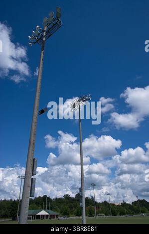 Field lighting poles against a blue sky Stock Photo
