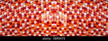 Geometric hexagonal red and orange metallic roof tiles Stock Photo