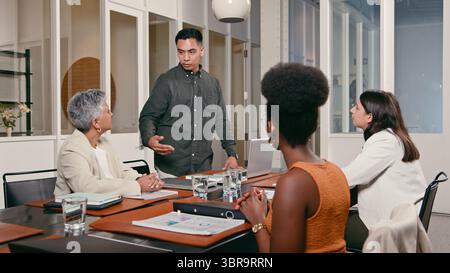 Team Collaborating in a Modern Office Setting During a Meeting Stock Photo