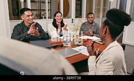 Group of Colleagues Enjoying a Productive Business Meeting, Applauding in a Professional Office Setting Stock Photo