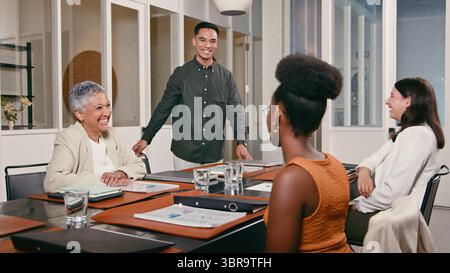 Collaborative Business Meeting Featuring a Smiling Group of Professionals in a Modern Office Setting Stock Photo