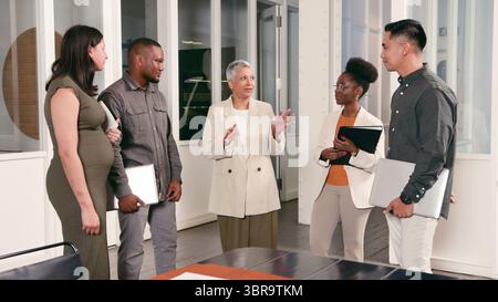 Professional Team Having an Office Discussion in a Modern Workspace Stock Photo