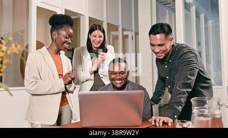 Diverse Team Collaborating in a Modern Office on a Successful Project Stock Photo