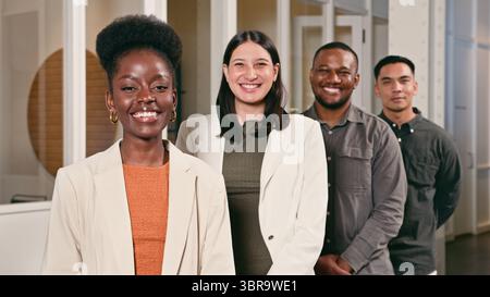 Diverse Professional Team Smiling Confidently in Modern Office Setting Stock Photo