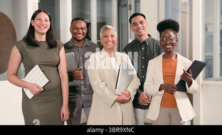 Group of Diverse Professionals Smiling in Modern Workspace, Showcasing Collaboration and Unity Stock Photo
