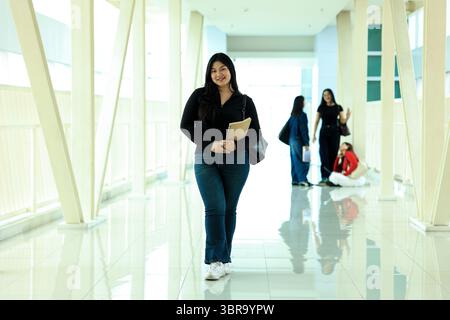Portrait Confident Young Asian Female College Student Standing on Campus Hallway Stock Photo