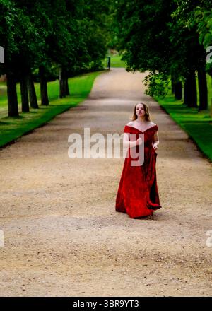 Woman with long red hair walks in weird forest . Ethereal and romantic ...