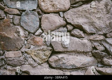 Ancient Cretan stone masonry with stones of different sizes Stock Photo
